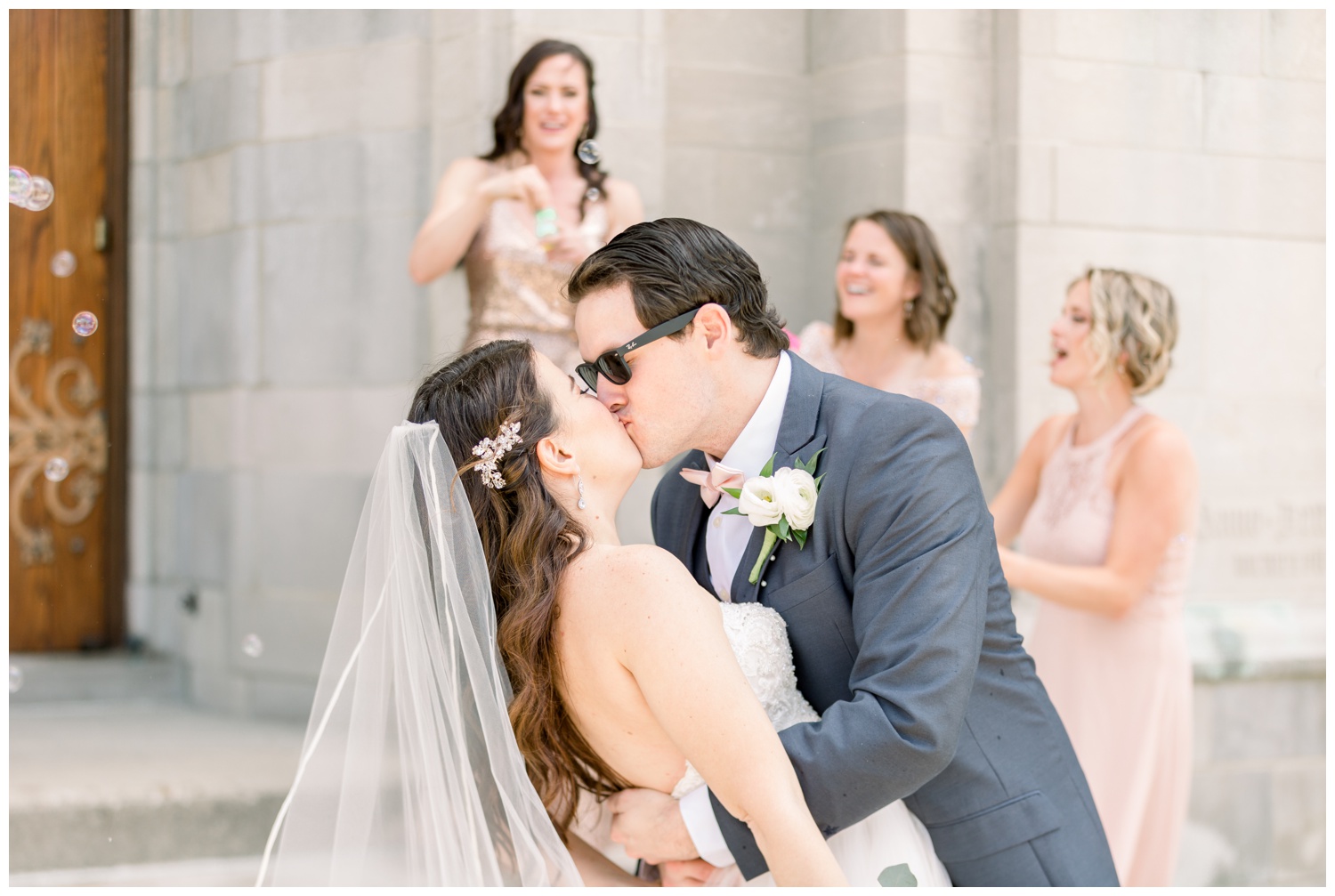Bride and Groom Kissing in Front of Church