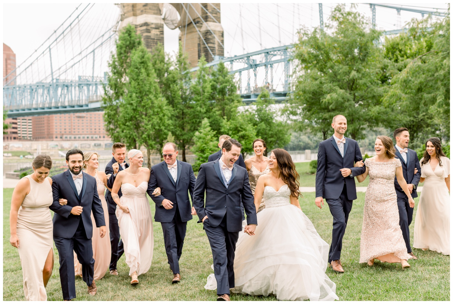 Bridal Party Walking at Smale Park in Front of Roebling Bridge