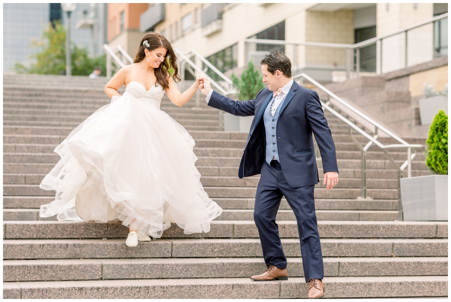 Bride and Groom Walking Down Steps at Smale Riverfront Park