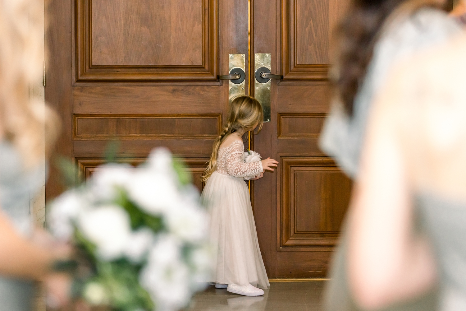 Flower Girl Peeking in Doors before Wedding at The Cincinnati Club
