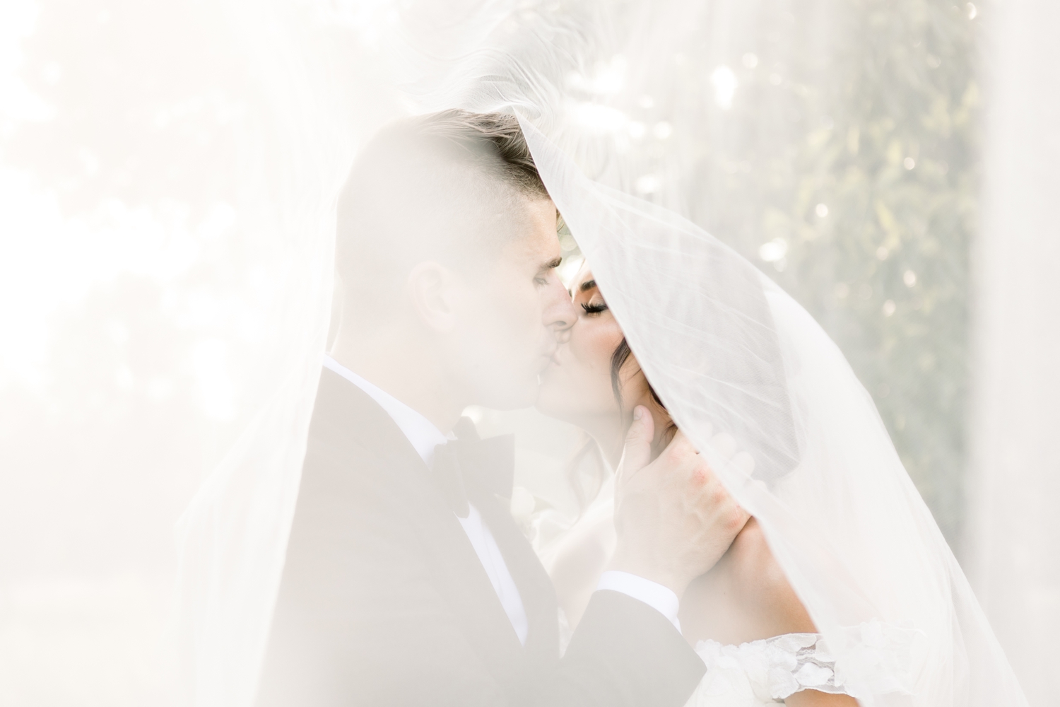 Bride and Groom Kissing Under Veil at Pinecroft Estate Cincinnati